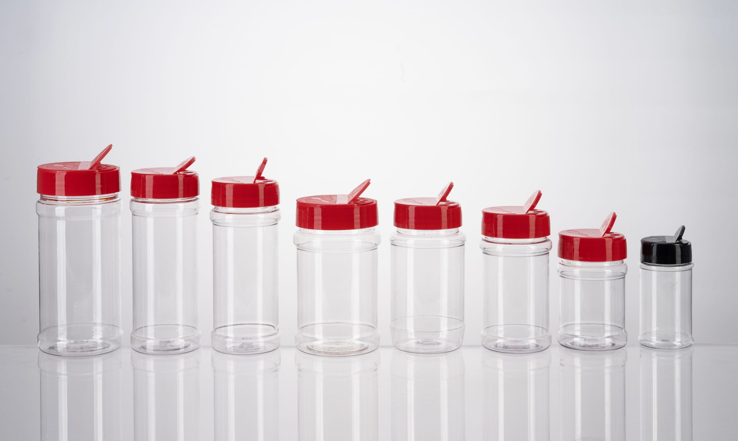 Clear PET square bottles stacked on pallets in a packaging production facility