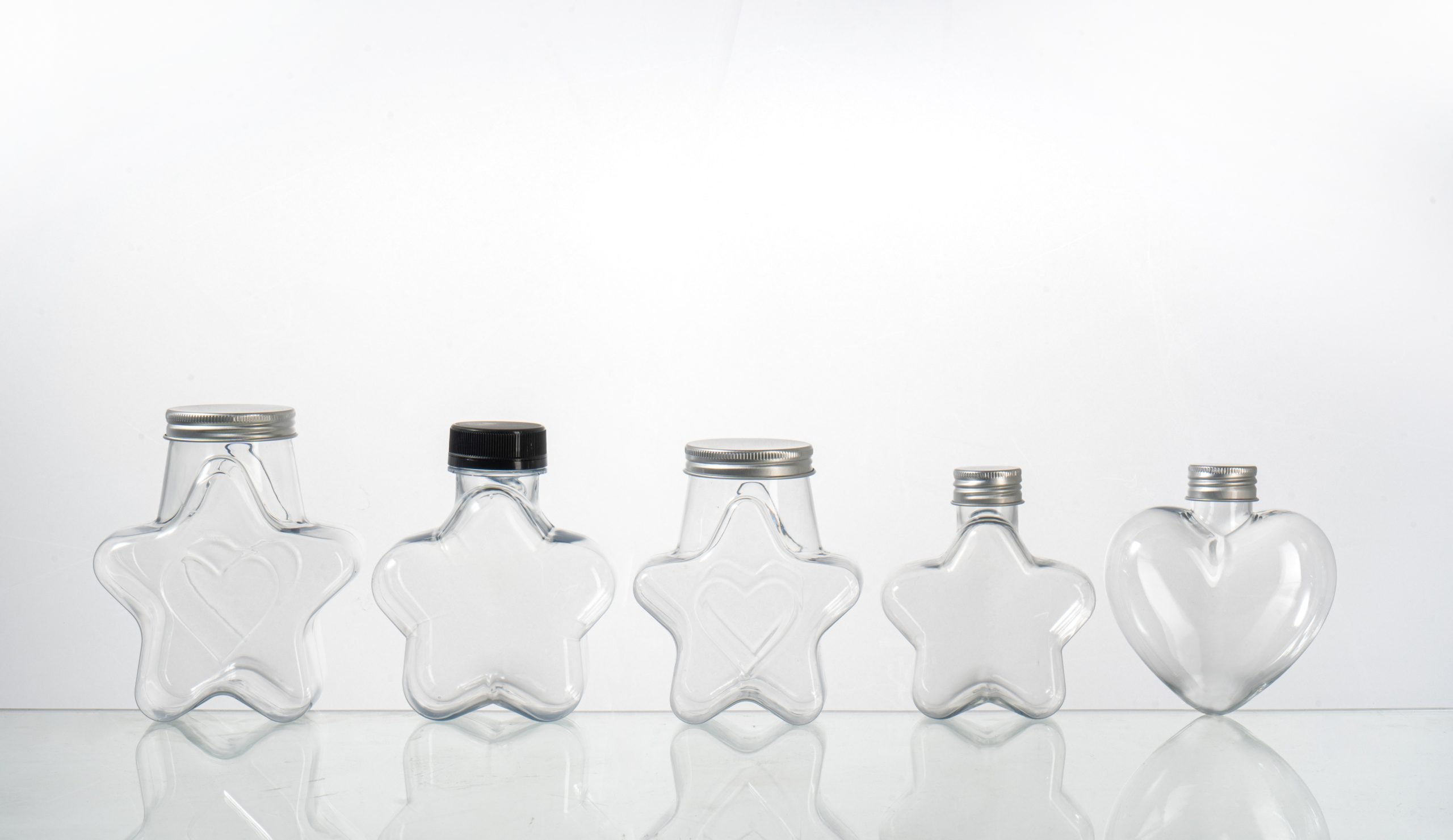 Clear PET square bottles stacked on pallets in a packaging production facility