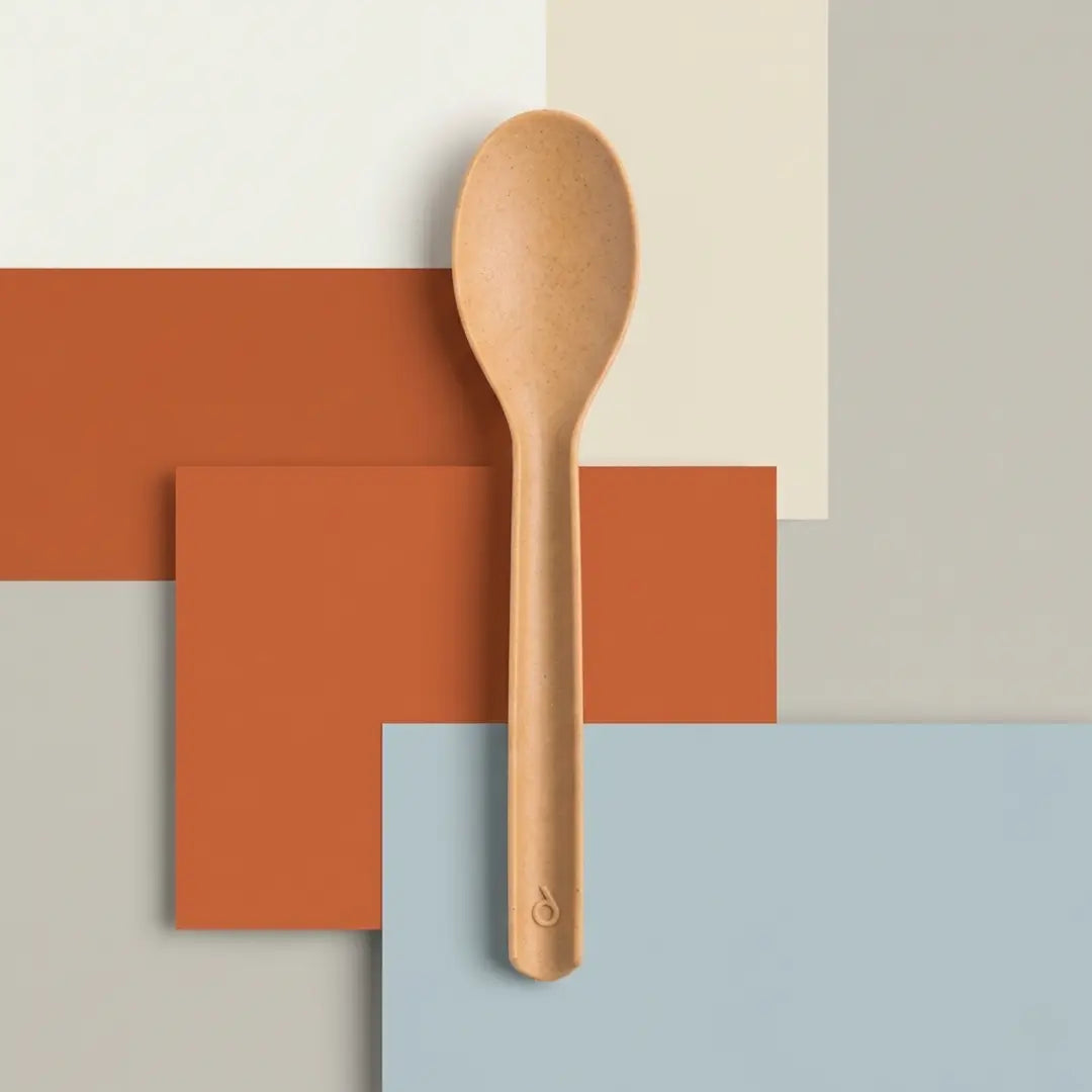 CompostEase plant fiber spoon on minimalist geometric background in warm earth tone colors